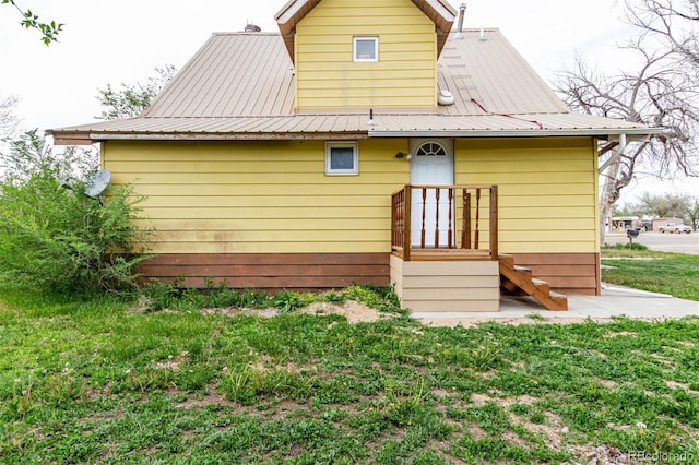 299 4th Ave, Limon, CO 80828 - rear view of house featuring metal roof and a lawn