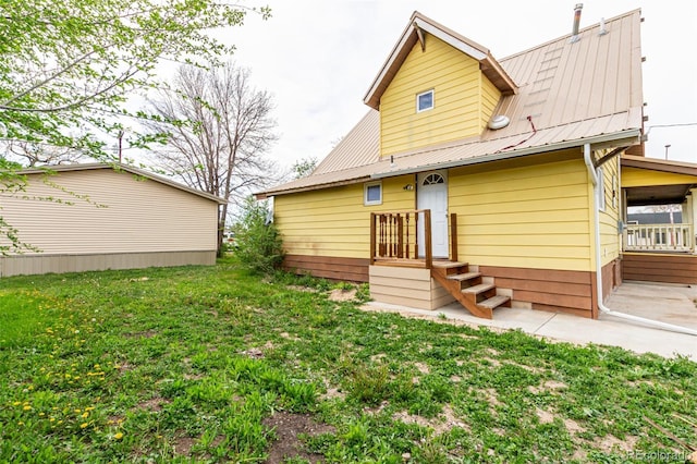 299 4th Ave, Limon, CO 80828 - back of property featuring metal roof and a yard
