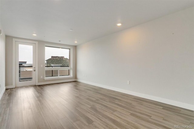 unfurnished room with light hardwood / wood-style floors