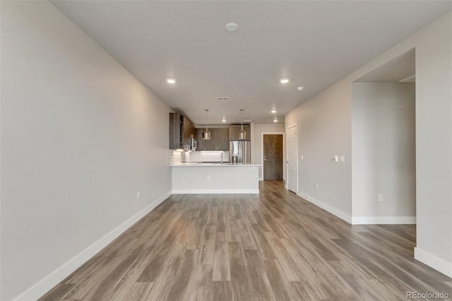 unfurnished living room with hardwood / wood-style floors