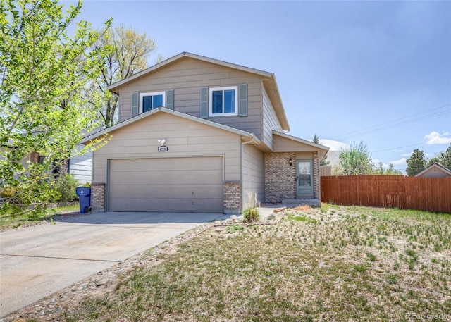 view of front of home with brick siding, a garage, fence, and driveway