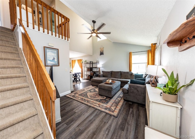 living area with wood finished floors, lofted ceiling, ceiling fan, stairway, and a textured ceiling