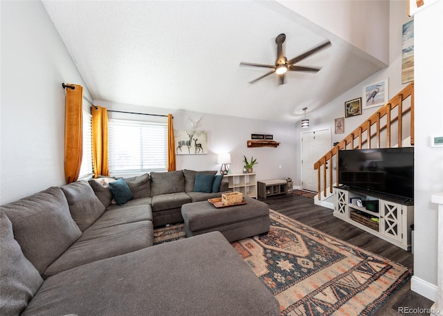 living room with stairs, a ceiling fan, wood finished floors, and lofted ceiling