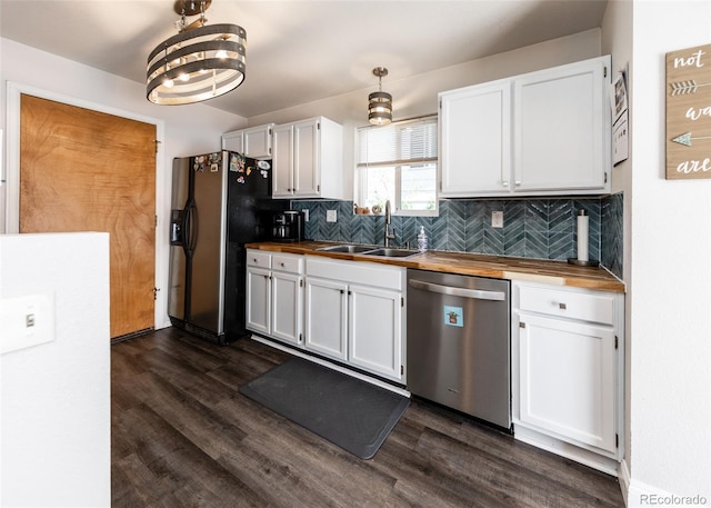 kitchen featuring stainless steel dishwasher, white cabinets, fridge with ice dispenser, a sink, and wood counters