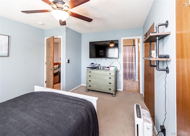 bedroom featuring baseboards, a ceiling fan, a textured ceiling, and light carpet