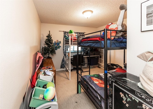 bedroom featuring a textured ceiling and carpet
