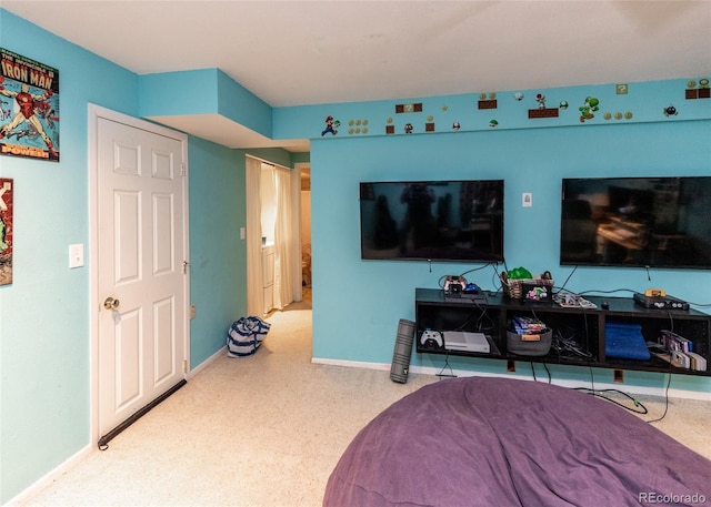 bedroom featuring baseboards and carpet