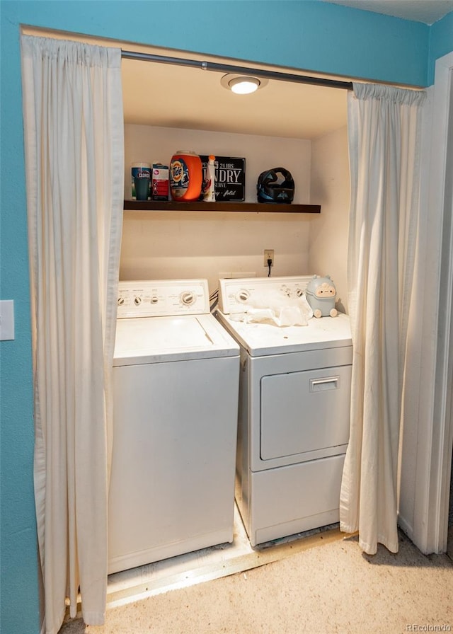 clothes washing area featuring separate washer and dryer and laundry area