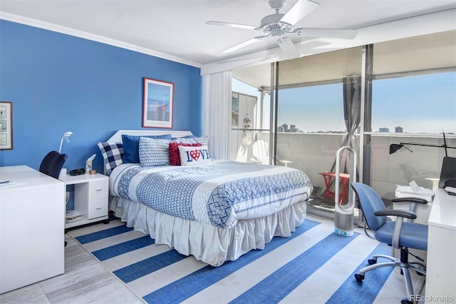 bedroom with ceiling fan, light wood-type flooring, and crown molding