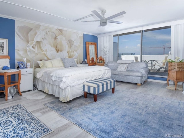 bedroom featuring ceiling fan, light hardwood / wood-style flooring, and ornamental molding