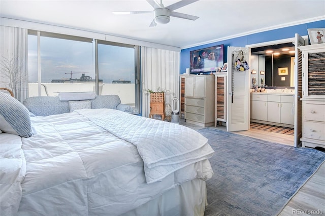 bedroom featuring ensuite bathroom, ceiling fan, crown molding, and light hardwood / wood-style flooring