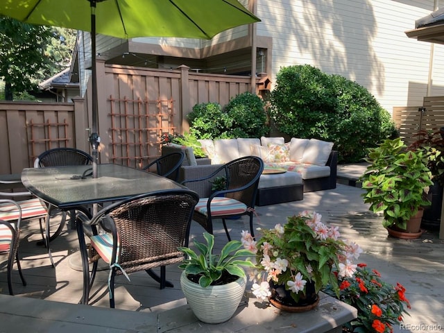 4565 E Mexico Ave Unit 3, Denver, CO 80222 - view of patio with an outdoor living space, outdoor dining area, and a wooden deck