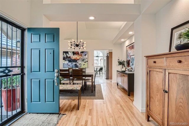 4565 E Mexico Ave Unit 3, Denver, CO 80222 - foyer entrance featuring light wood-type flooring, a chandelier, lofted ceiling, and recessed lighting