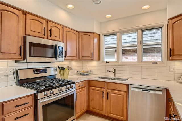 4565 E Mexico Ave Unit 3, Denver, CO 80222 - kitchen featuring appliances with stainless steel finishes, light countertops, tasteful backsplash, and recessed lighting