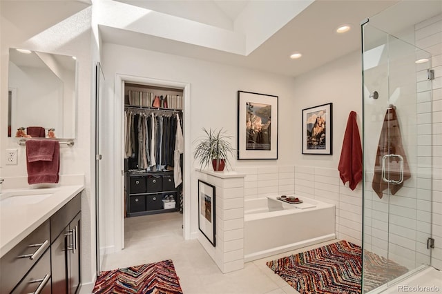 4565 E Mexico Ave Unit 3, Denver, CO 80222 - bathroom featuring a shower stall, vanity, a garden tub, a spacious closet, and recessed lighting