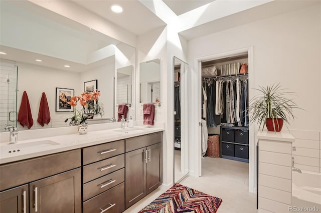 4565 E Mexico Ave Unit 3, Denver, CO 80222 - full bath with double vanity, recessed lighting, a walk in closet, and a bathtub