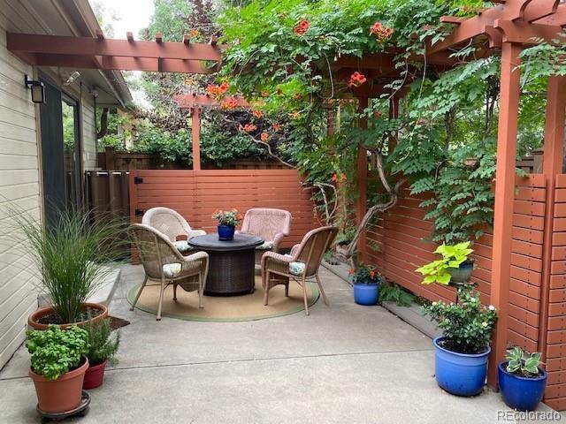 4565 E Mexico Ave Unit 3, Denver, CO 80222 - view of patio featuring a pergola and outdoor dining area