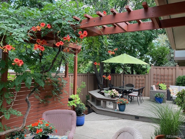 4565 E Mexico Ave Unit 3, Denver, CO 80222 - fenced backyard with outdoor dining space, a pergola, and a wooden deck