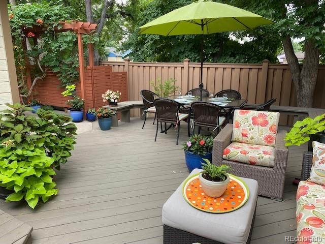 4565 E Mexico Ave Unit 3, Denver, CO 80222 - wooden deck with outdoor dining area