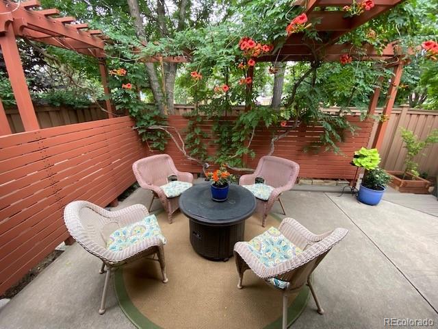 4565 E Mexico Ave Unit 3, Denver, CO 80222 - fenced backyard with a patio area and a pergola