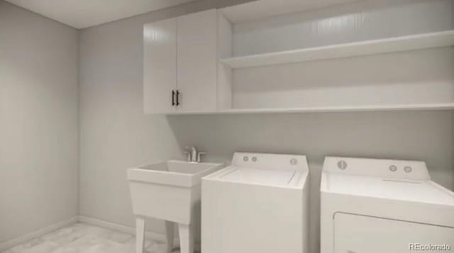 4565 E Mexico Ave Unit 3, Denver, CO 80222 - laundry area featuring light marble finish floors, washing machine and dryer, and cabinet space