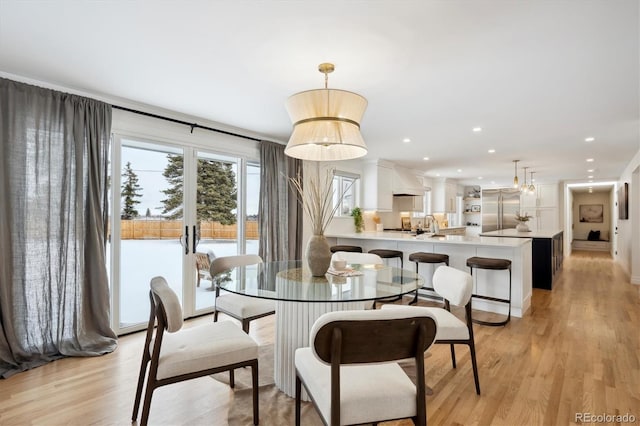 dining space with light wood-type flooring, french doors, and recessed lighting