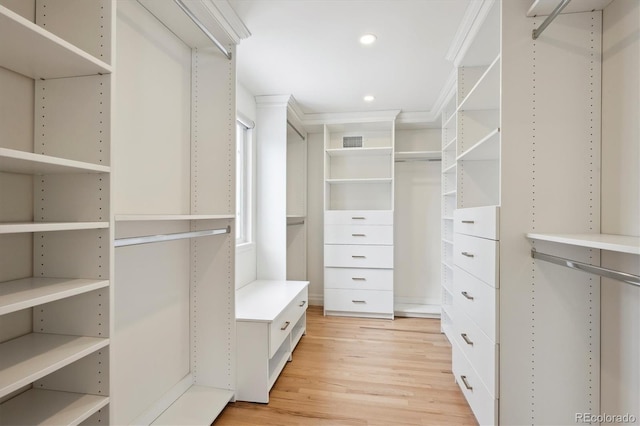 spacious closet with light wood-type flooring and visible vents