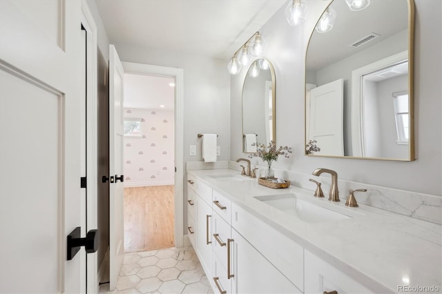 full bathroom with double vanity, tile patterned flooring, a sink, and visible vents