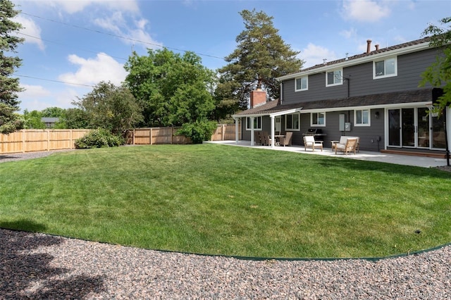 view of yard featuring a patio area and a fenced backyard