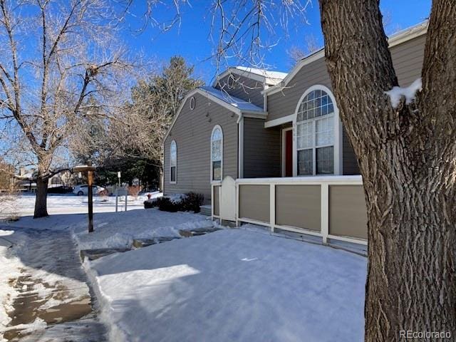 view of snowy exterior with a garage