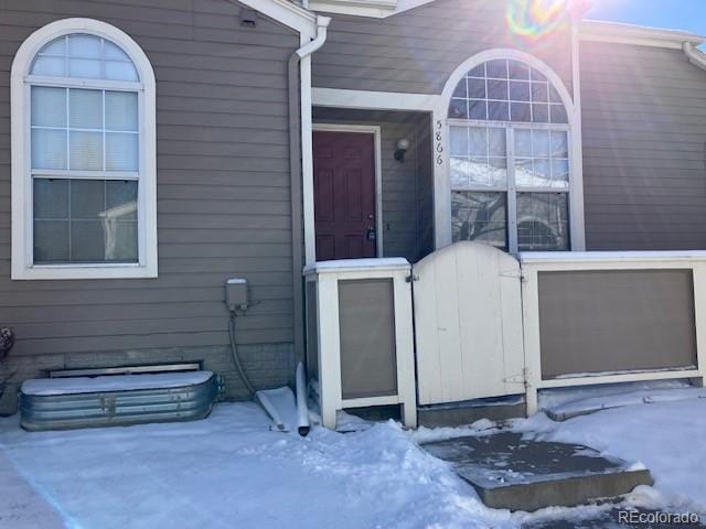 view of snow covered property entrance