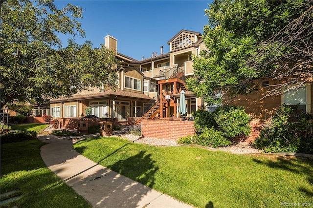 6001 S Yosemite St Unit B206, Greenwood Village, CO 80111 - rear view of property with a lawn, stairway, and a chimney