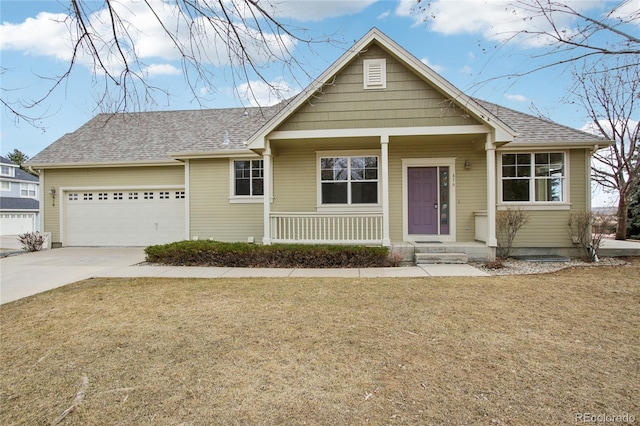 view of front of home with a garage, roof with shingles, concrete driveway, and a front yard