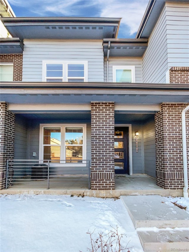 view of snow covered property entrance