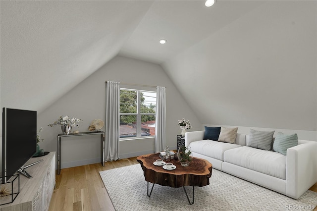 living room with recessed lighting, vaulted ceiling, light wood-style flooring, and baseboards