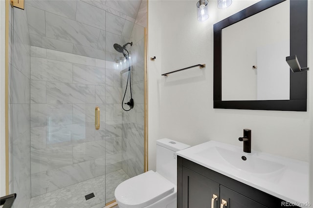 bathroom featuring a shower with door, vanity, and toilet