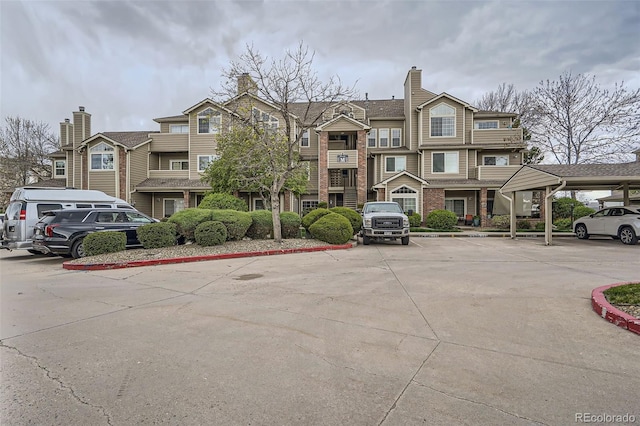 view of property with covered and uncovered parking
