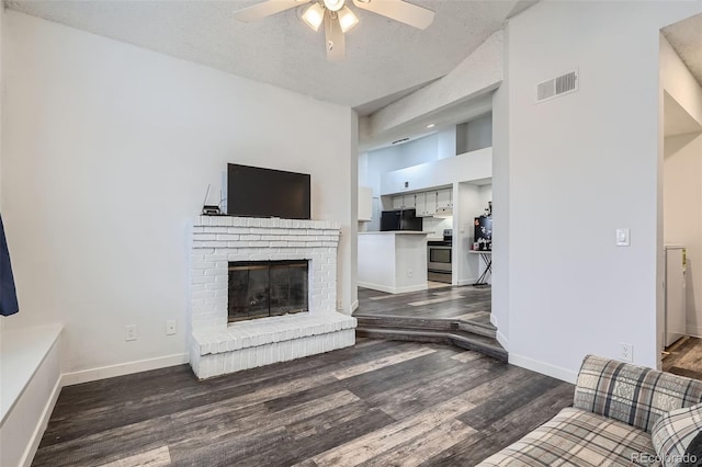 living area with visible vents, a ceiling fan, baseboards, and wood finished floors