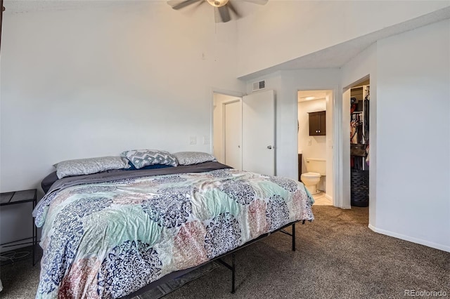 bedroom with a walk in closet, carpet floors, a ceiling fan, visible vents, and a closet