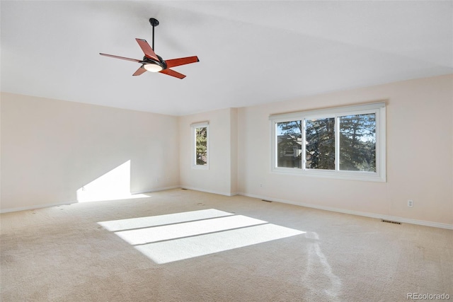 carpeted empty room featuring ceiling fan