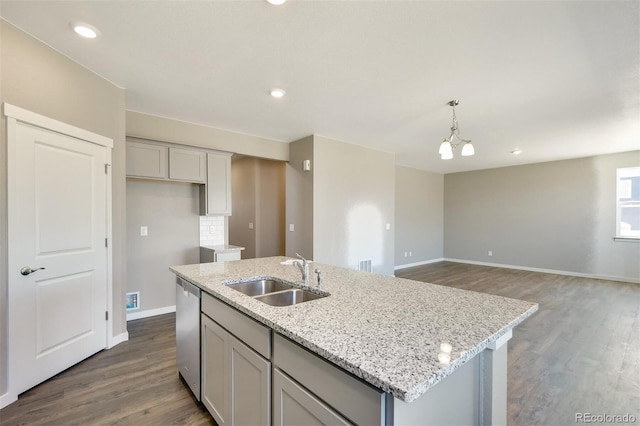 9910 Biscay St, Commerce City, CO 80022 - kitchen featuring dark wood finished floors, a kitchen island with sink, light stone countertops, gray cabinetry, and recessed lighting
