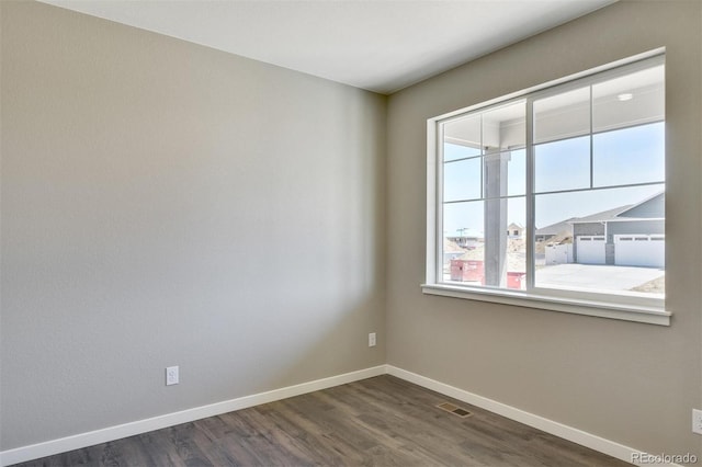 9910 Biscay St, Commerce City, CO 80022 - unfurnished room with baseboards and dark wood-type flooring