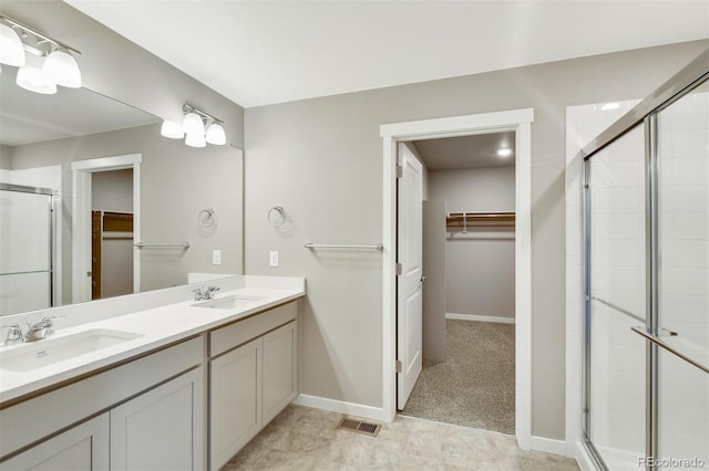 9910 Biscay St, Commerce City, CO 80022 - full bathroom featuring a walk in closet, double vanity, and a shower stall