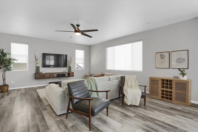 living room featuring light wood-type flooring and ceiling fan