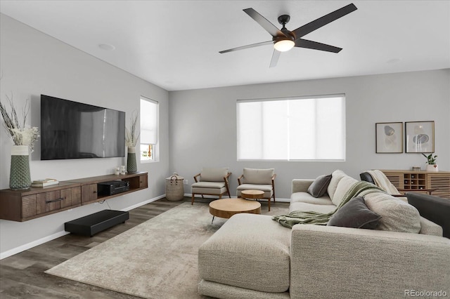 living room featuring dark hardwood / wood-style flooring and ceiling fan