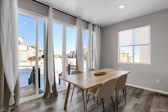 dining room with dark hardwood / wood-style floors and plenty of natural light