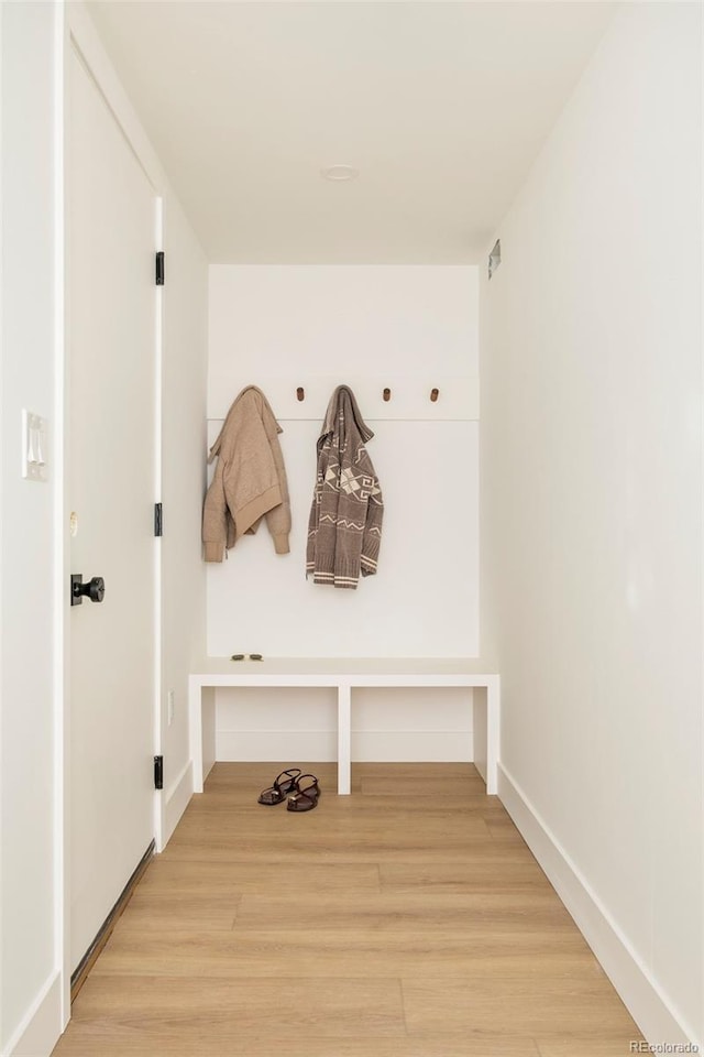 mudroom featuring wood finished floors and baseboards