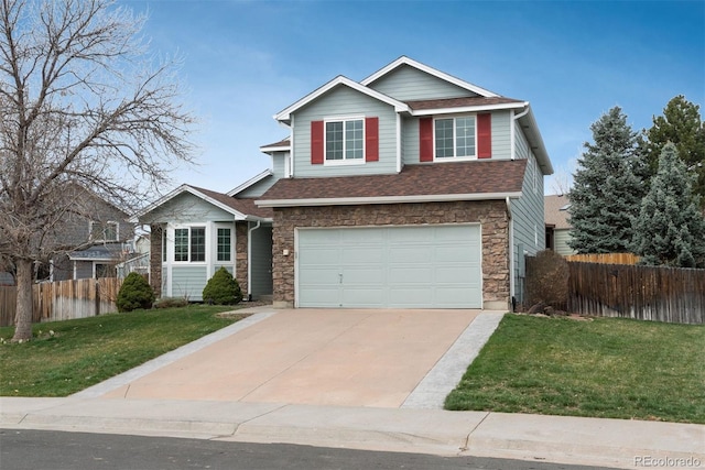traditional-style house featuring fence, stone siding, concrete driveway, a garage, and a front lawn