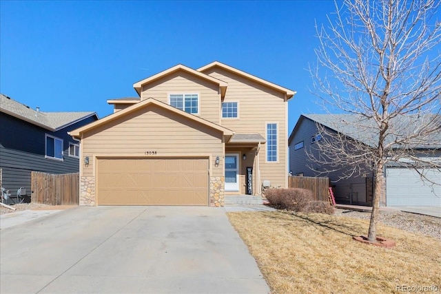 traditional-style home with driveway, stone siding, a garage, and fence