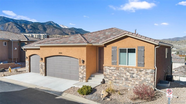 view of front facade with a mountain view and a garage